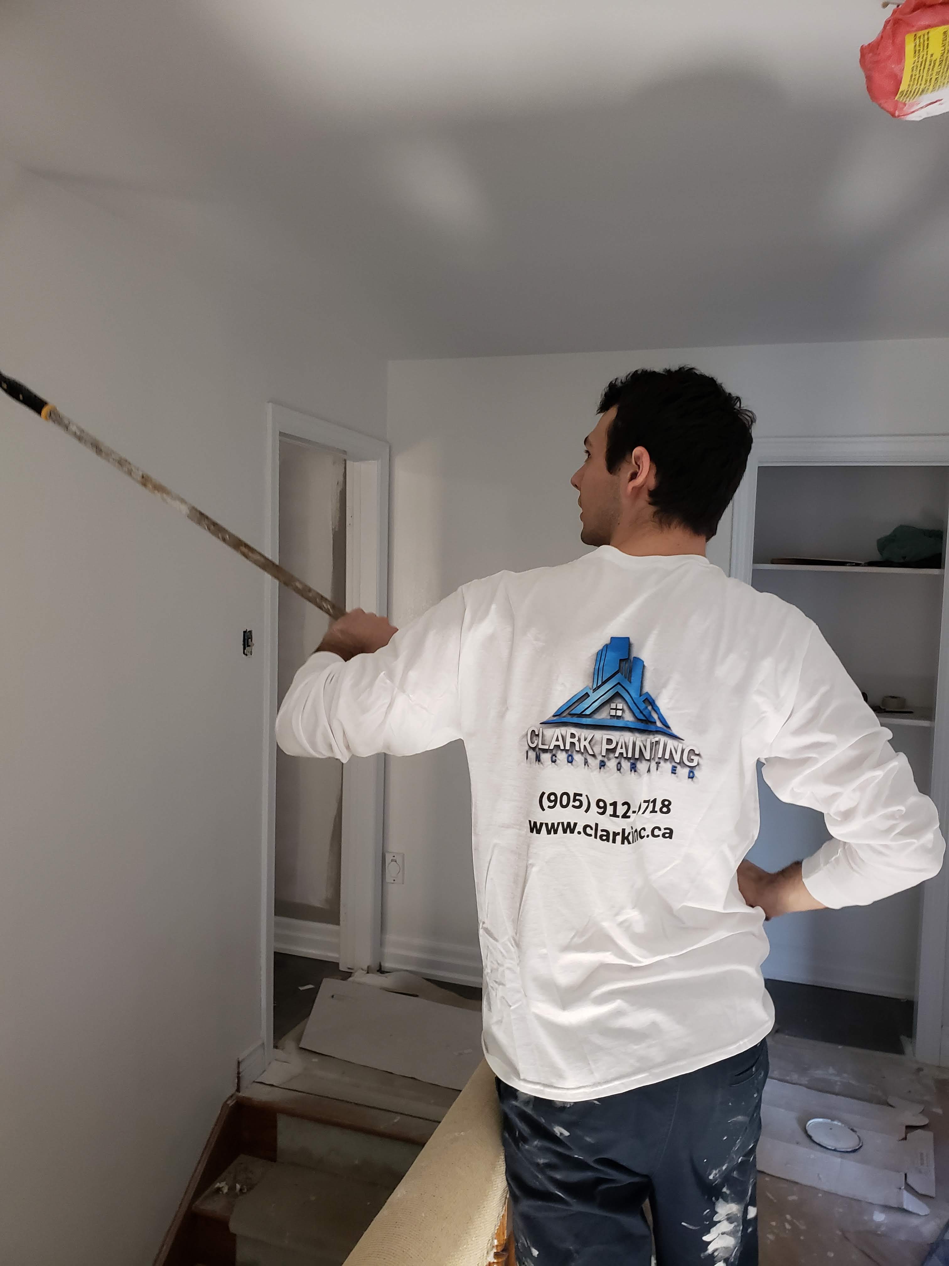 Brad painting in a Clark Painting shirt